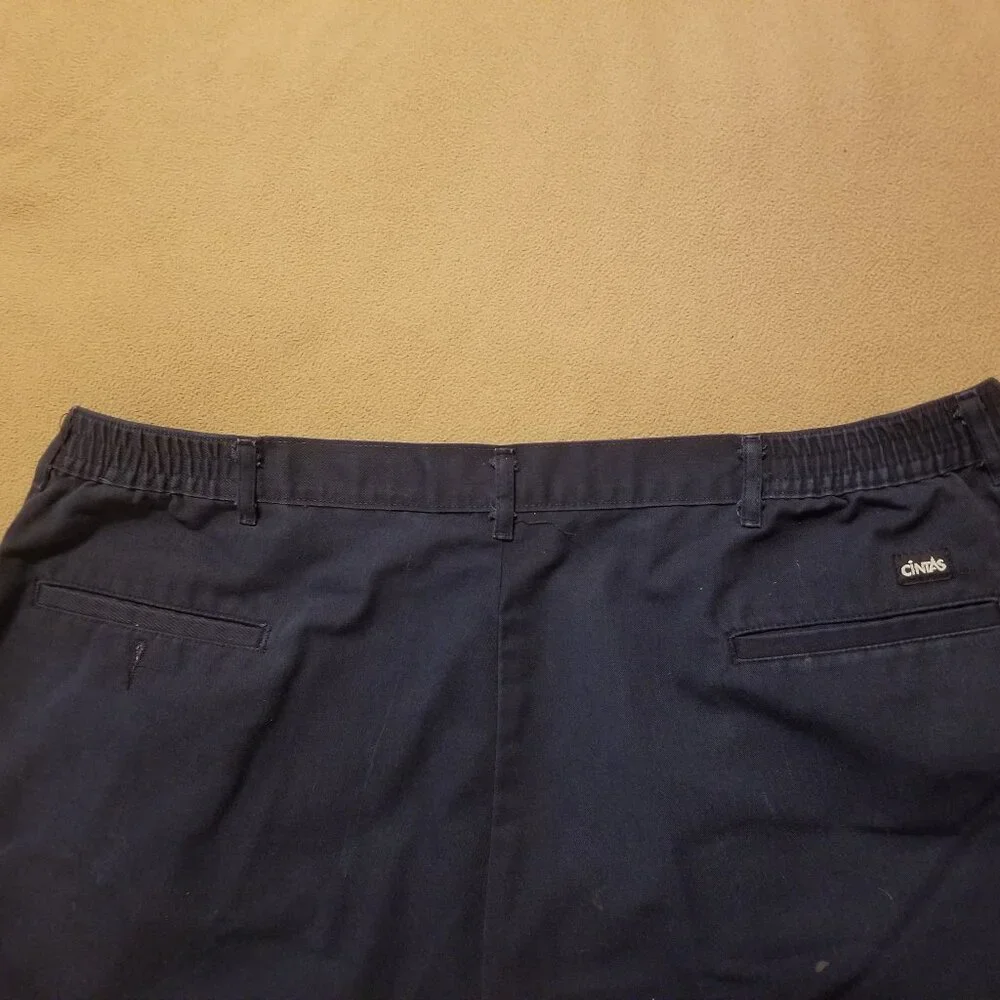 Three stained Cintas men's pants with stretching waistbands
